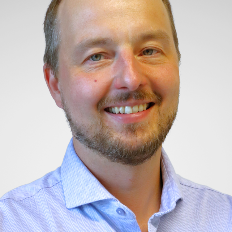 A man looking at the camera and smiling.