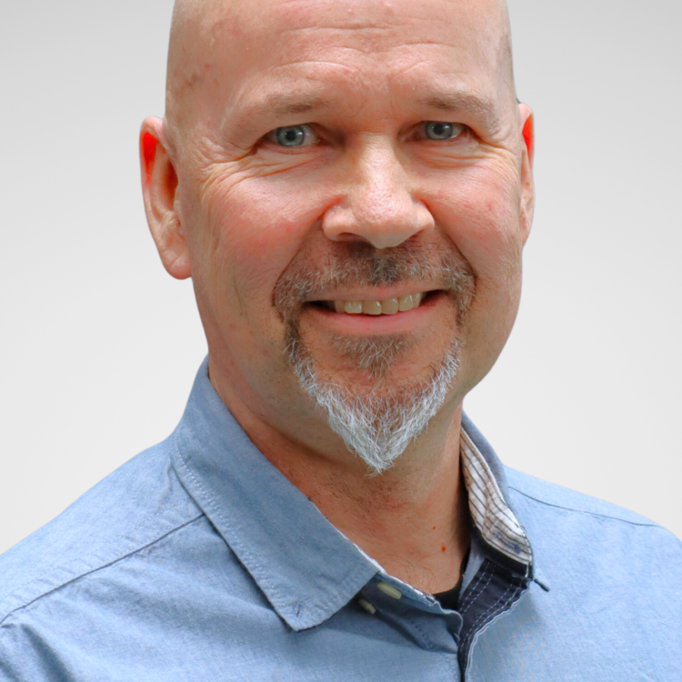 A man looking at the camera and smiling.