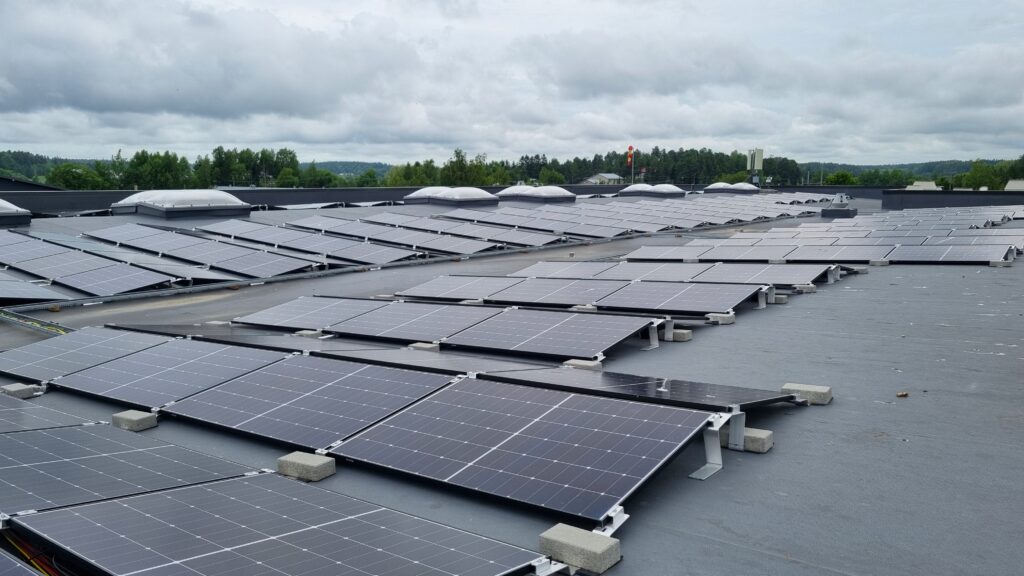 The roof of the production facility with numerous solar panels.