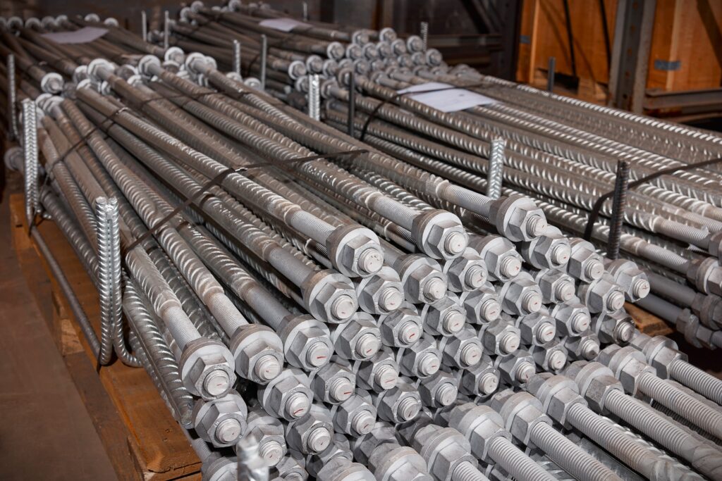 Hot-dip galvanized threaded bolts bundled on pallets.