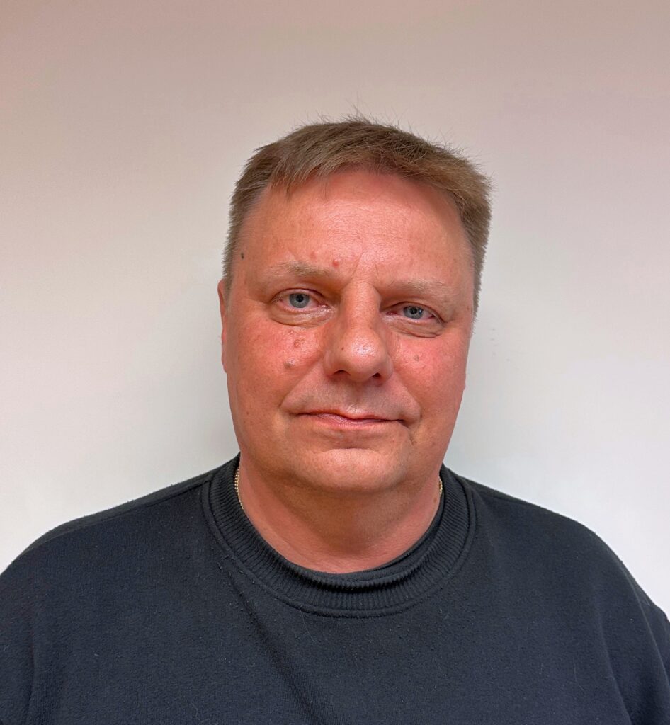 A man looking at the camera and smiling.