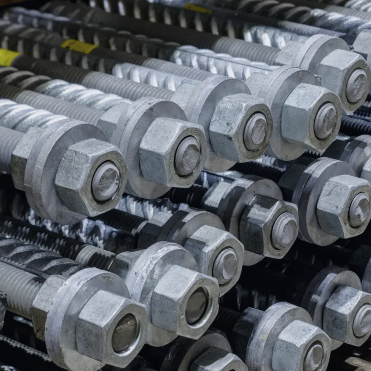 Hot-dip galvanized threaded bolts bundled on pallets.