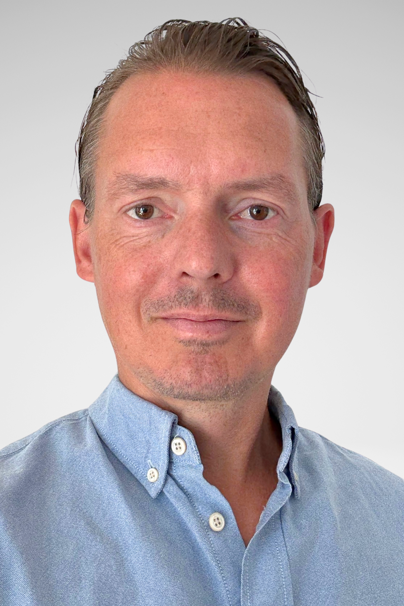 A man looking at the camera and smiling.